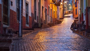 Taken before dawn in a light rain in Guanajuato, Mexico. The water slicked cobles brilliantly reflected the streetlights and sky.